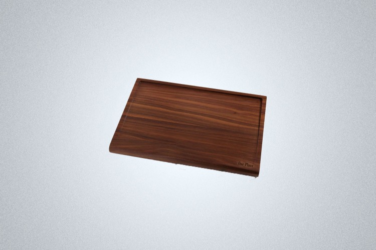 The Our Place Walnut Cutting Board on a gray background